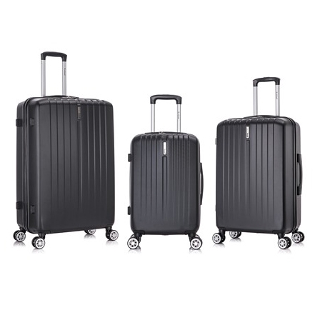 Three black, hard-shell rolling luggage pieces with horizontal ridges, each varying in size, equipped with telescoping handles and four spinner wheels.
