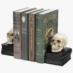 Skull bookends hold up a row of books with varied covers, including titles related to art and history.