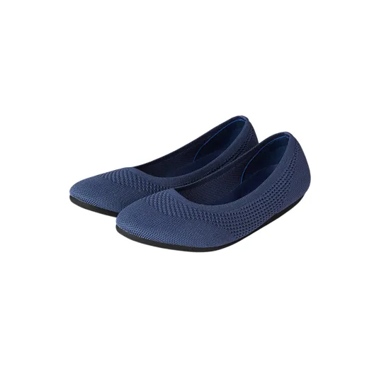 A pair of navy blue knit ballet flats with rounded toes and textured detailing.