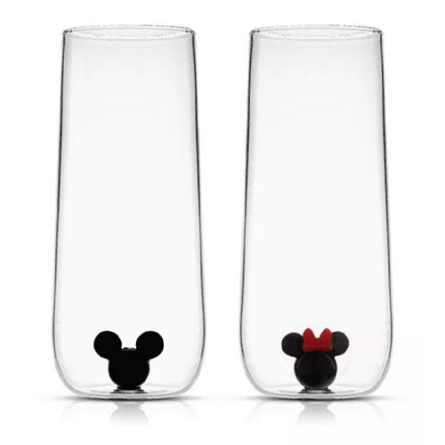 Set of two tall clear glasses with black mouse ear designs at the base; one with a red bow.