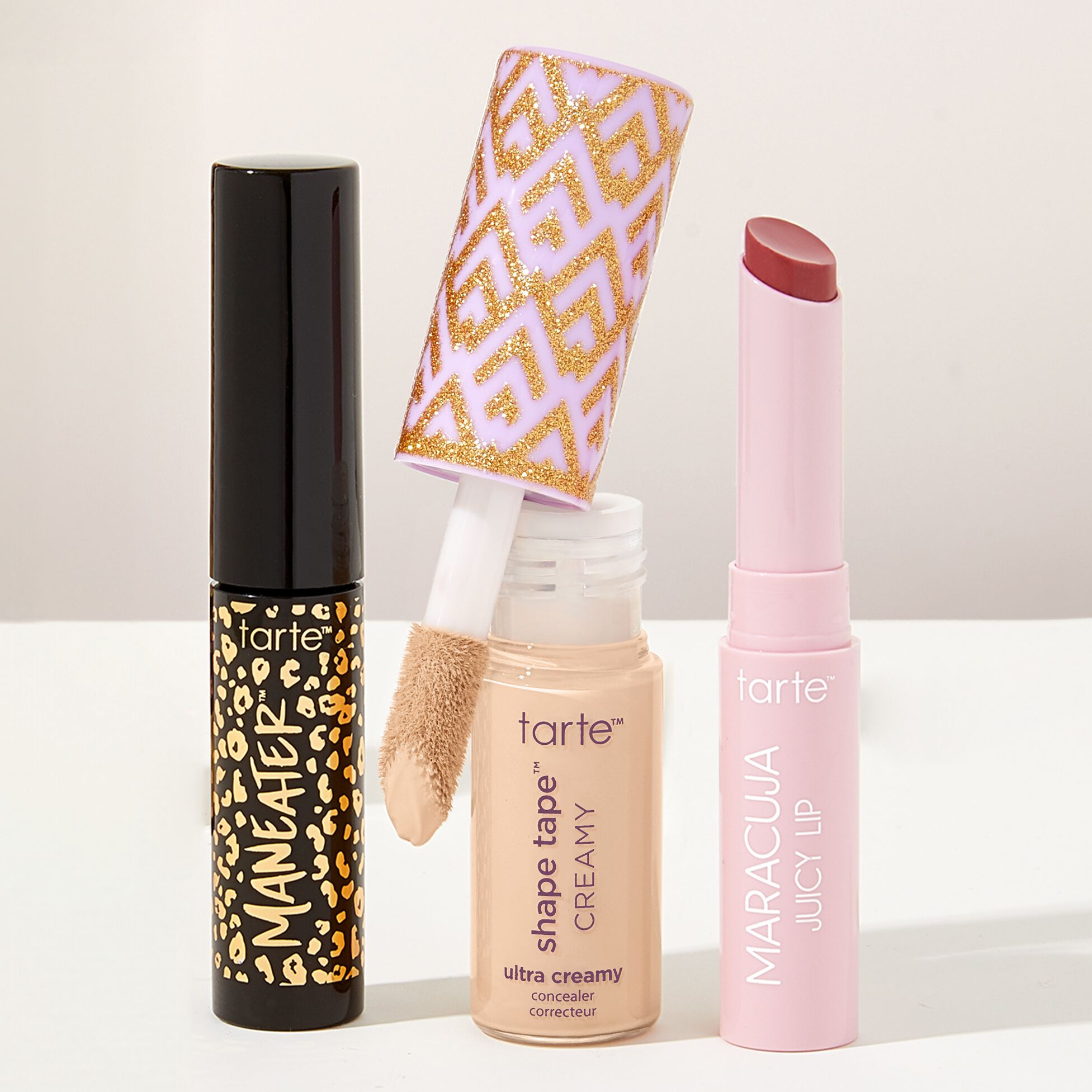 Three Tarte cosmetics: Maneater mascara, Shape Tape ultra creamy concealer, and Maracuja Juicy Lip.