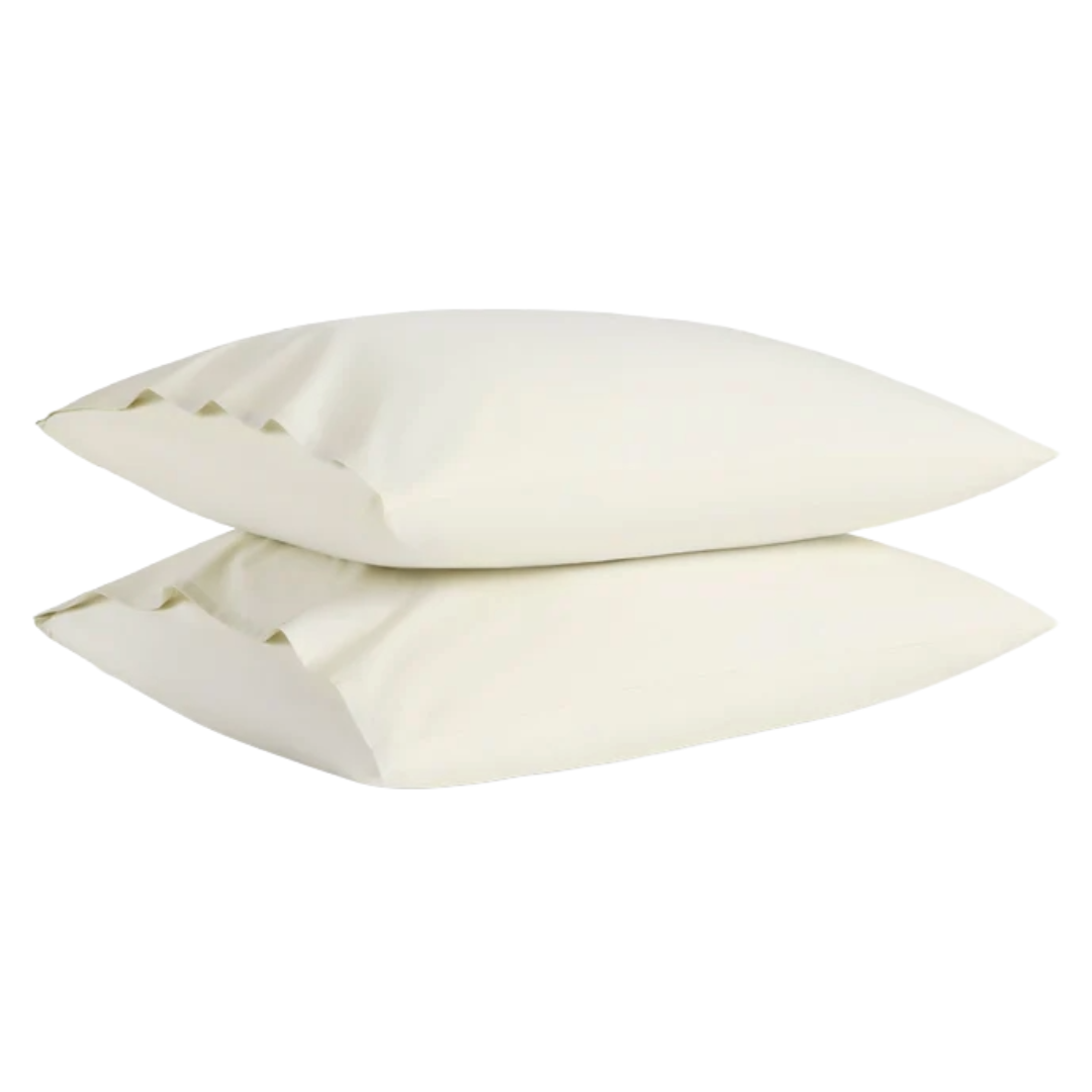 Two stacked beige pillowcases with a simple design.
