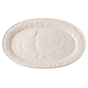 White ceramic platter featuring an embossed turkey design with a decorative fruit border.
