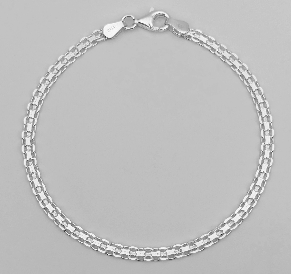 Silver chain bracelet with lobster clasp closure.