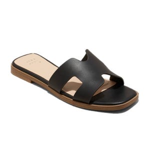 A black slide sandal with a wide strap featuring cut-out detailing, brown sole, and open toe design.