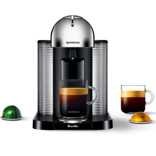 Nespresso coffee machine by Breville with two coffee cups and two capsules.