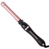 A Beachwaver B1 curling iron with a pink barrel and black handle, featuring a digital control and rotation buttons.