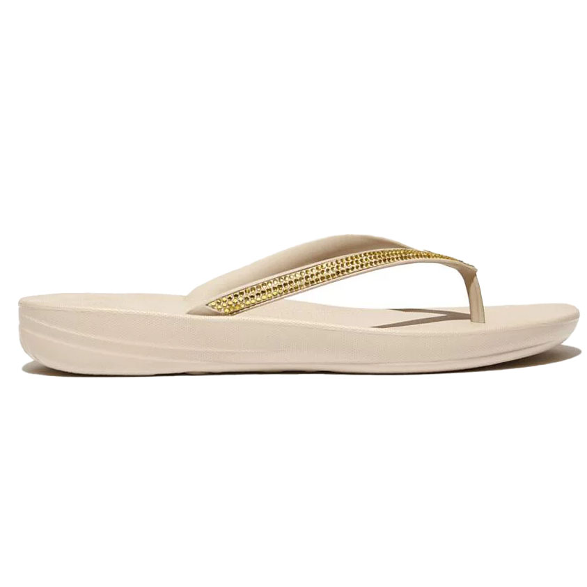 Beige thong-style sandal with a simple design and gold glitter on the straps, featuring a cushioned sole for comfort.